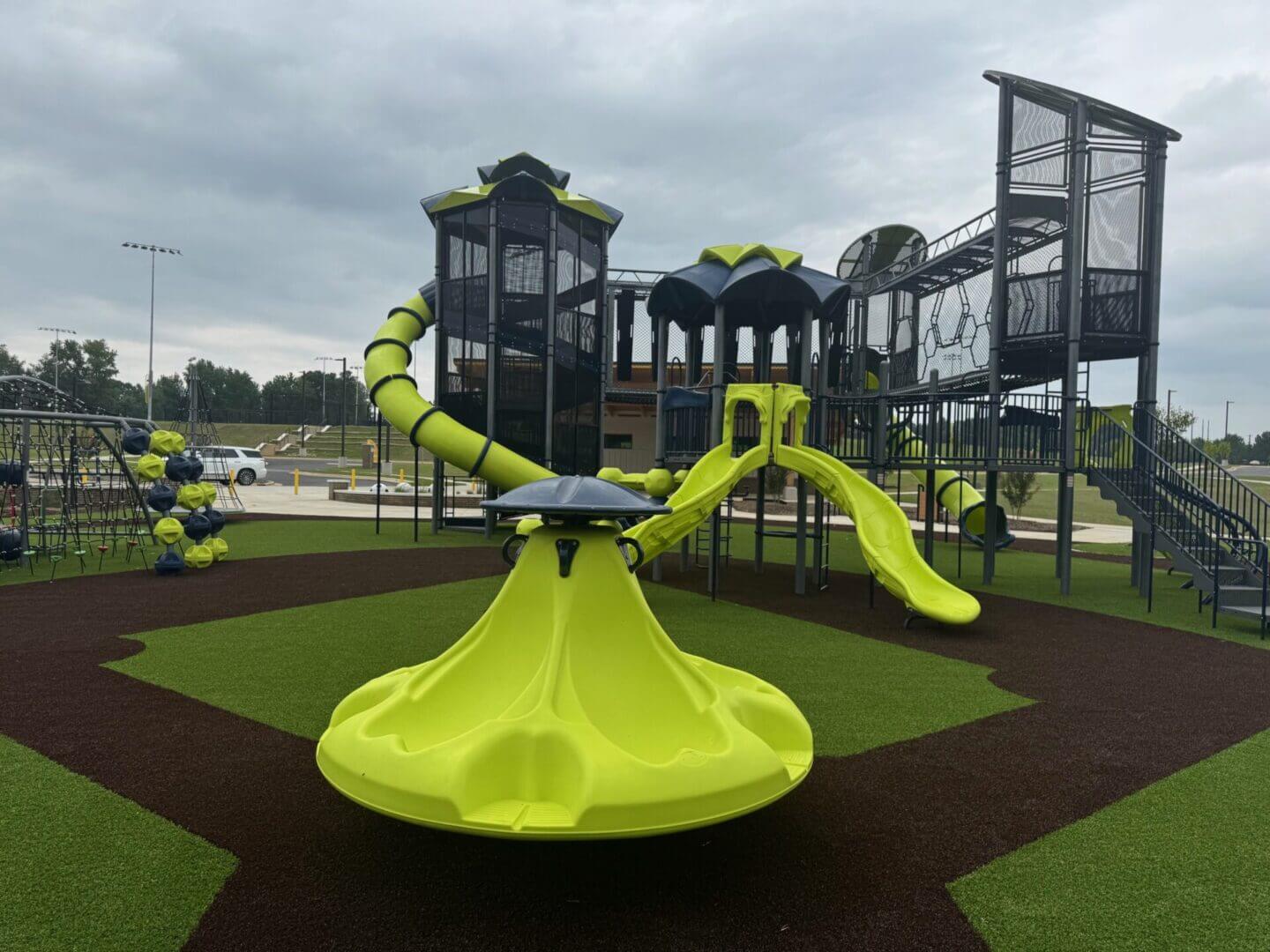 Bright green playground structure with spiral slide